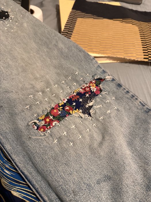 Plus-sign sashiko pattern over the repair
