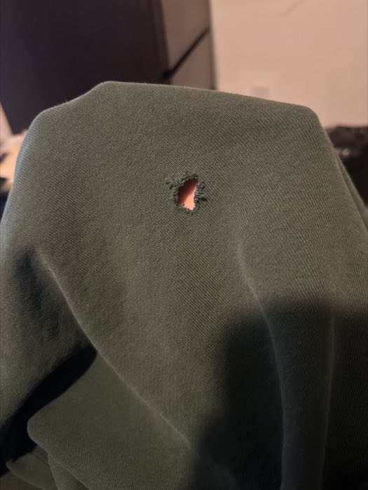 Worn sweatshirt before repair